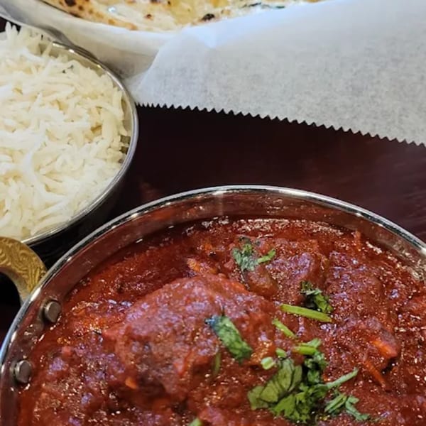Close-up of Spice Kitchen's Indian butter chicken, rice, and naan bread.
